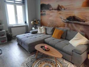 a living room with a couch and a table at Odra River Condo in Szczecin +3 photos