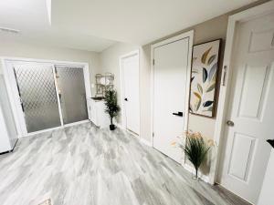 an empty living room with white walls and wood floors at Oxon Hill Cosy Middle Unit 2 bedroom and 1bath near Gaylord in Oxon Hill
