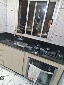 a kitchen with a sink and a stove top oven at Apto 8° andar, 4 min do shopping. in São Paulo