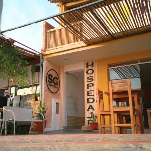 a store front with a sign that reads sgarma at SGH Paracas Hospedaje in Paracas