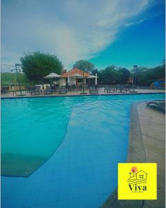 a swimming pool at a resort with a building in the background at Apto GRAVATÁ ASA BRANCA D12 04 in Gravatá
