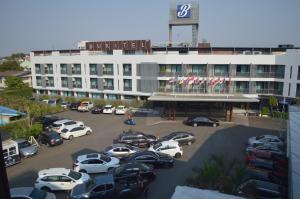 a parking lot with cars parked in front of a building at Buritel Hotel in Buriram +57 photos