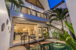 a villa with a swimming pool and a house at Villas Krisna Canggu WCS in Canggu