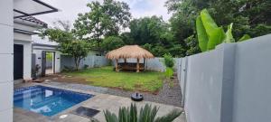 a villa with a swimming pool and a house at Villa indah in Beber