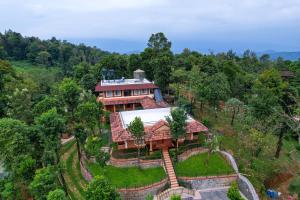 an aerial view of a house in the forest at Wild Courtyard Wayanad Resort in Wayanad