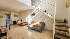 a living room with a couch and a staircase at Duplex Apartment in Larnaka