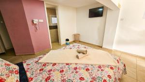 a room with a bed with a pair of shoes on it at Duplex Apartment in Larnaka