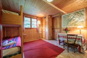 a bedroom with a bed and a table in a room at Chalet L’eau vive - Happy Rentals in Chamonix-Mont-Blanc +20 photos
