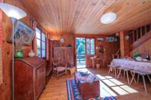 a living room with a table in a wooden house at Chalet L’eau vive - Happy Rentals in Chamonix-Mont-Blanc