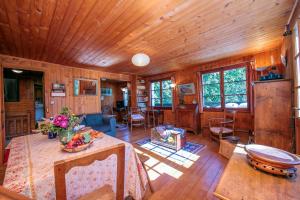 a living room with a table and a wooden ceiling at Chalet L’eau vive - Happy Rentals in Chamonix-Mont-Blanc