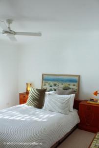 a bedroom with a bed with a painting on the wall at Frankston South Beachside Gem in Frankston South