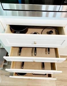 an open drawer of a kitchen cabinet withartmentsigunigunigunigunigunigunigun at Newly remodeled beauty in Phoenix in Phoenix