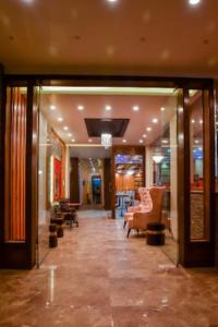 a lobby with couches and chairs in a building at BLISS GANGA RISHIKESH , Uttarakhand in Rishīkesh