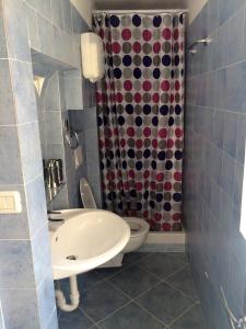 a bathroom with a sink and a toilet and a shower at La Piazza B&B in Vercurago