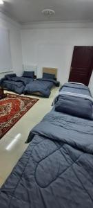 a room with three beds sitting on the floor at العنبرية2 in Al Madinah