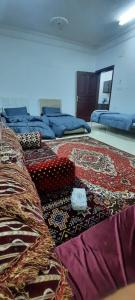 a room with several beds and a rug on the floor at العنبرية2 in Al Madinah