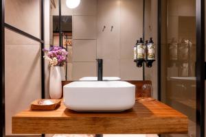 a white toaster sitting on top of a wooden counter at DOURWIN Exclusive Suites & Restaurant - Adults Only in Sebolido +37 photos