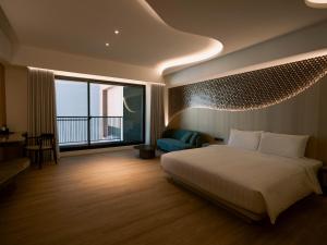Posteľ alebo postele v izbe v ubytovaní XIUXI Anping Hotel