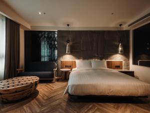 Ένα ή περισσότερα κρεβάτια σε δωμάτιο στο XIUXI Anping Hotel