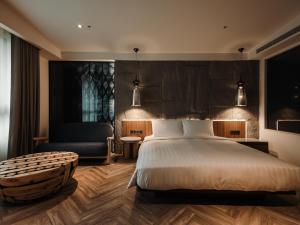 Posteľ alebo postele v izbe v ubytovaní XIUXI Anping Hotel