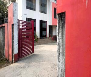 a red gate in front of a building at Mountain Green Club and Resort in Siliguri