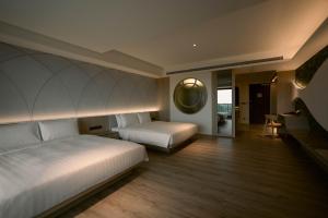 Posteľ alebo postele v izbe v ubytovaní XIUXI Anping Hotel