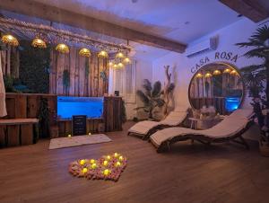 a living room with chairs and a large screen tv at CASA ROSA, Un petit Cocon Catalan in Ortaffa