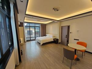 a hotel room with a bed and a table at Guilin Meishe Homestay in Guilin