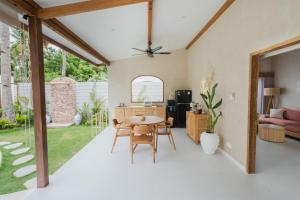 a kitchen and living room with a table and chairs at Gili Boho Villas - Aesthetic Private Pool Villas in Gili Trawangan