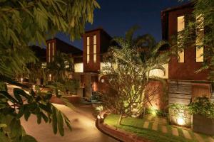 a house with lights in front of it at night at Aalia Villas Anjuna, Goa by Aalia Collection in Anjuna