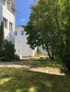 um quintal com uma árvore e um edifício em Lägenhet med egen ingång. em Sundsvall