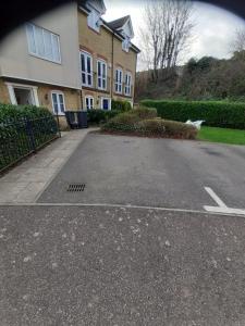 an empty parking lot in front of a house at Lovely and Spacious Room with Conservatory in Gravesend