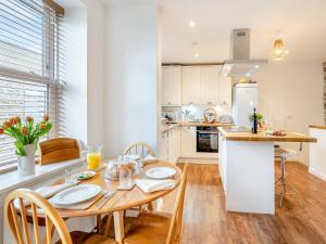 a kitchen and dining room with a wooden table and chairs at Winter Cottage 