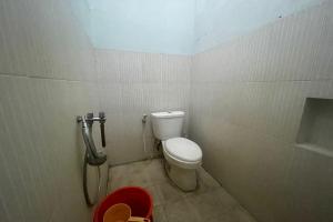 a small bathroom with a toilet and a shower at OYO 93609 Syukur 07 Syariah in Medan