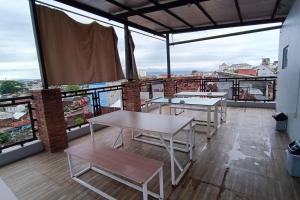 a balcony with tables and benches on top of a building at OYO 93607 Penak Malioboro Bunk Bed in Yogyakarta