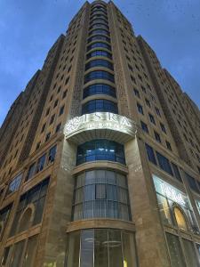 a tall building with a lot of windows at IsraHotel Dushanbe in Dushanbe