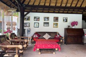a living room with a couch and a table at Belvilla Pleasant Seaside Lovina Beach in Lovina