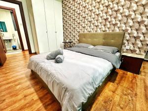 a bedroom with a large bed with a large headboard at YM Homestay Vivacity megamall Jazz Suite 3 bedroom 8 pax in Kuching