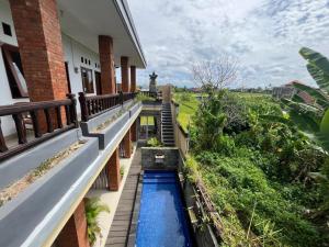 a view of a balcony with a water feature at Sublime Seaside Villa Near Sunset Beach Tanah Lot in Tanah Lot