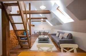a living room with a couch and a table at Elevante Residence in Poprad