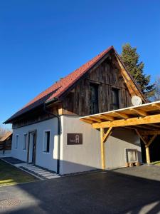 a small house with a wooden roof on top of it at Arnfels Residences am Tor zur Südsteirischen Weinstraße in Arnfels