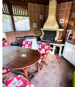 a kitchen with a wooden table and a stove at Apartman De Lux in Nyíregyháza