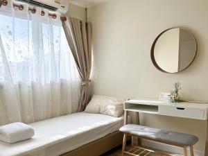 a window seat in a room with a mirror at Happiness Sleep C1 in Pak Kret