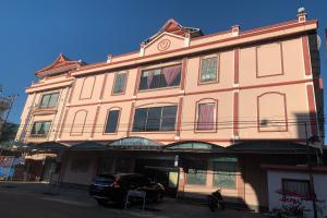 a building with a car parked in front of it at OYO 93665 Puri Homestay in Kendari