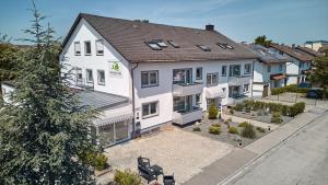 an overhead view of a white house at Marias Inn - Bed & Breakfast in Garching bei München