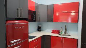 a kitchen with a red refrigerator and a sink at Spacious Studio walking distance to the Ocean, Unit 1 in Catano