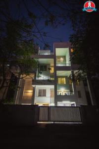 a large white building at night with lights at Atithi Service Apartment in Pune