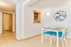 a white dining room with a white table and chairs at APARTAMENTO Nº 8 SA PERDIU in Son Carrio