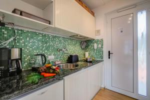 a kitchen with a sink and a counter top at Il Piccolo Nido - Happy Rentals in Riva del Garda