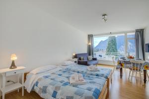 a bedroom with a bed and a large window at Il Piccolo Nido - Happy Rentals in Riva del Garda
